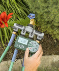 Automatic Yard Watering System With Four Station Sprinkler Setup showing easy dial controls in garden setting