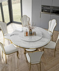 Kickback Ready Round Marble Dining Table Built For Epic Weekend Hangouts Featuring A Smooth White Spinning Lazy Susan And Bold Gold Stainless Steel Base Stretching Fifty Nine Inches Wide with elegant chairs.