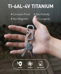 Badass Titanium Keychain Carabiner Multitool With Bottle Opener shown in hand with keys, made of corrosion-proof TI-6Al-4V titanium.
