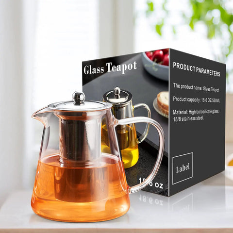Stovetop Safe Glass Teapot 550ml With Removable Stainless Steel Infuser, displayed with packaging in a kitchen setting.