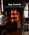 On Camera RGB LED Light With 6000mAh Battery, App Control Via Bluetooth, illuminating a model beside bookshelves