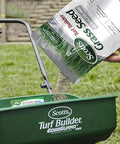 Pouring Quick Kickstart Yard Patch Grass Seed Mix for fast bare spot repair into a spreader on grassy area.