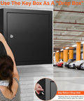 Wall-mounted 100 Key Cabinet Lock Box With Anti Theft Function And Key Tags installed in a garage, showing key return drop slot.