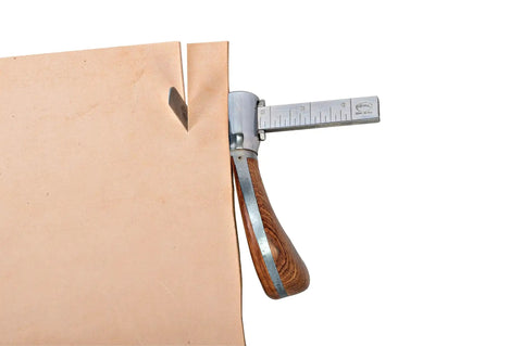 Right Handed Draw Gauge With Handcrafted Exotic Wood Grip and Hella Smooth Twist Lever measuring leather strap width.