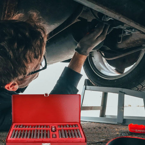 Using a 40 Piece Socket Wrench and Hex Bit Driver Set with Spline and 12 Point Star Bits for Auto Repair under a vehicle.