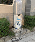 Heavy Duty Ev Charger Rain Cover For Electric Vehicle Stations Ultra Weatherproof Outlet Guard Box protecting a charging station outdoors.