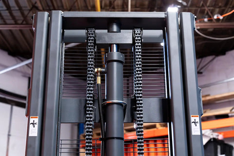 Heavy Duty Fully Electric Adjustable Straddle Stacker Delivers Solid 3300 Pound Capacity And Snappy 11 Foot 6 Inch Lift close-up of hydraulic system and chains.