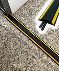 Heavy Duty Floor Cable Management Protector Tubing For Home Gym And Warehouse Cords shown on stone floor