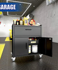 35 Inch Adjustable Shelf Tool Storage Cabinet With Rollin Smooth Locking Casters And Locked Tight Heavy Duty Frame For Professional Garage Workspace Setup In Deep Matte Black with visible storage and tools.