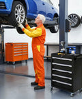 Heavy Duty Rolling Tool Chest With Five Drawers And Smooth Ball Bearing Slides For Garage Workshop Organization next to a mechanic servicing a vehicle.