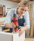 800W Palm Router Tool For Woodworking in action with 12 piece 1/4 inch bit set, woman routing wood edge, durable aluminum build