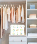 Stackable Storage Bins With Lids, 16.5 By 12.6 By 11.8 Inch Foldable Closet Organizers in a modern closet with hanging clothes.