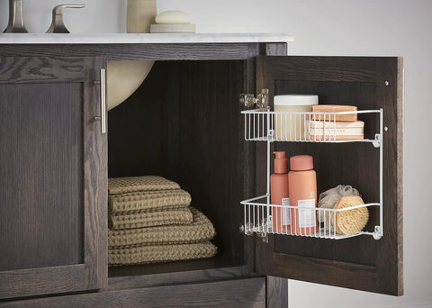 Slick Two Tier Wall Rack For Cabinet Doors And Walls, Heavy Duty Epoxy Coated Steel Storage Shelf In Crisp White displaying bath supplies.