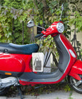 Durable Outdoor Waterproof Electrical Outlet Cover For Universal Charging Stations and Cord Storage Box on red scooter in garden.