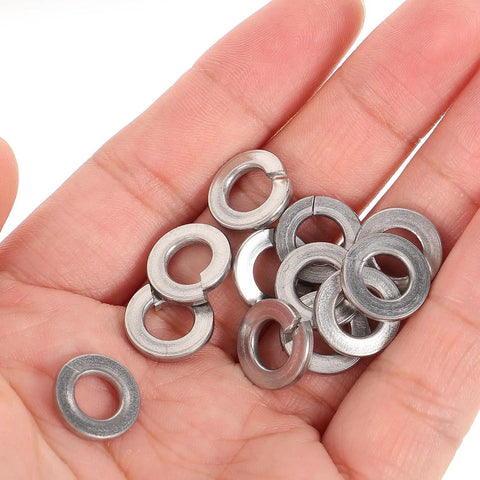 Pro Stash Stainless Steel Spring Lock Washers 1/4 Inch 100 Pack split rings in hand, rust proof fasteners for secure bolts.