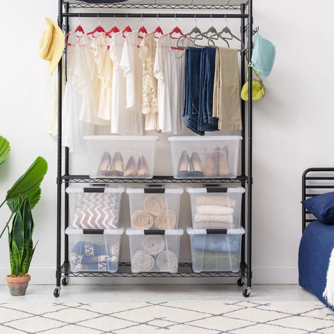 32 Quart Clear Plastic Storage Bins With Easy Snap Lids Stackable Home Organization Totes For Closet Bedroom Garage filled with clothes and shoes.