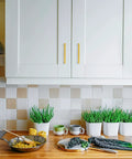 Brushed Brass Cabinet Pulls Hella Sturdy Drawer Handles For Kitchen Cabinets And Dressers Five Inch Center Spacing on white cabinets in stylish kitchen.