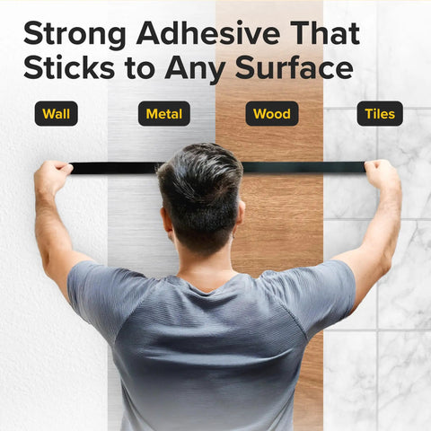Person testing magnetic tape's adhesive strength on wall, metal, wood, and tiles. Magnetic Tape With Adhesive Backing 10 Feet Long By Half Inch Wide DIY Friendly Lightweight Magnetic Strip For Crafts And Organization Easy To Cut And Mount On Fridges And Whiteboards That Sticks For Light Duty Labels And Mounts