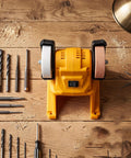 Top Shelf Mini Bench Grinder With 18V Compatible Battery For Precision Sharpening And Metal Polishing Portable Workstand on a wooden table.