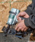 Person holding nailer with shank visible, using One And A Quarter Inch Pneumatic Roofing Nails 7,200 Count Electro Galvanized