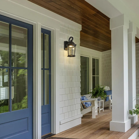 Heavy Duty Led Motion Sensor Outdoor Wall Light With 800 Lumens Super Bright 3000K Warm White Glow, Dusk To Dawn Safety Switch, Rugged Black Metal And Clear Water Glass Finish For Secure Front Porch Garage Shed Illumination That Hits Just Right, mounted on a white porch wall.