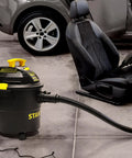 Powerful 5 Gallon Wet Dry Shop Vacuum With 4 Peak HP, 85 CFM, 3 In 1 Blower cleaning car interior in garage