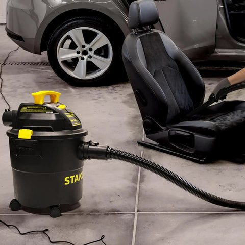 Powerful 5 Gallon Wet Dry Shop Vacuum With 4 Peak HP, 85 CFM, 3 In 1 Blower cleaning car interior in garage