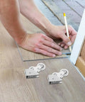 Four Piece Heavy Duty Aluminum Pulley Rollers For Smooth Sliding Doors And Windows Straight Up Quick Swap Garage Track Replacement Hardware laid beside a person marking a floor.