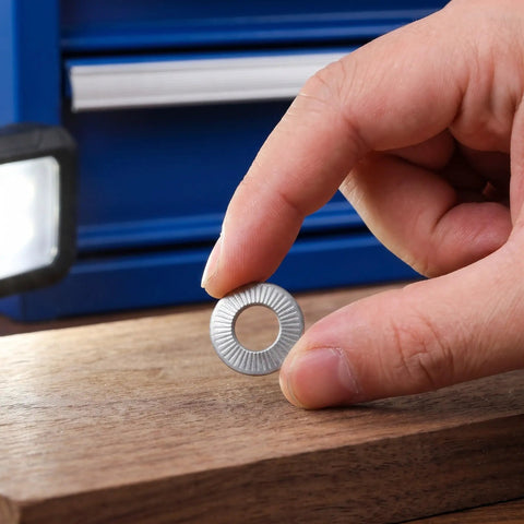 Hand holding a Tough As Nails M6 Conical Spring Washer from a 40 Pack 304 Stainless Steel, showing knurled lock design.