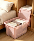 Sick Space Saver Pink Plastic Storage Bin Knocking Clutter Out With 18 Gallon Stackable Tote holding neatly rolled towels beside a bed.