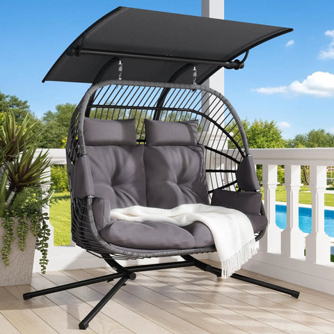 Double Egg Chair With Removable Adjustable Canopy for Outdoor Hangout Patio Balcony, grey cushioned, set on a wooden deck