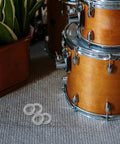 Heavy Duty Metal Wedge Locking Washers For Drum Rack Mounting Hardware and Cymbal Stand secure fasteners next to a wooden drum set.