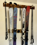 Badass Five Pack Ski Wall Hangers Securely Grip Every Alpine Board From Rockers To Racers And Kids Patented Design Saves Tip Wear While Keeping Your Garage Storage Dead Slick with mounted skis on wall.
