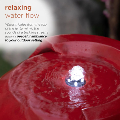 Close-up of the LED glow and water flow on 33 Inch Outdoor Vintage Cascading Antique Jar Water Fountain With LED Lights Red Finish For Garden, Patio And Yard Decor, Soothing Water Flow And Ambient Glow To Elevate Your Outdoor Space And Create A Chill Vibe.