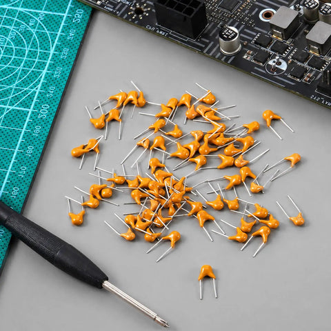 Sweet Ceramic Capacitor Assortment Kit featuring ten darn reliable microfarad values on a workspace with a soldering tool.