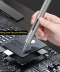 Hand holding Tiny But Mighty Mini Electric Screwdriver Kit 69 In 1 Cordless Precision Tool on circuit board