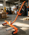 Heavy Duty 660 Lbs Adjustable Tire Wheel Dolly Built Dang Tough For Garages With Ultra Smooth Eight Inch Rollers in a warehouse.