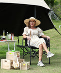 Woman relaxing on Oversized Directors Camping Chair With Side Table, Heavy Duty Folding Lawn Chair For Adults, Supports 400 Lbs, outdoors