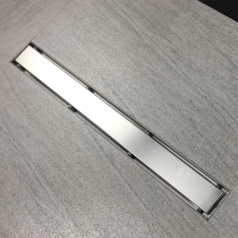 Super Sleek 12 Inch Linear Shower Drain With Brushed Finish And Sweet Tile Insert Cover in a sleek bathroom setting.