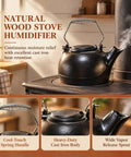 Solid Cast Iron Wood Stove Steamer And 3 Qt Humidifier Kettle with chrome handle releasing gentle steam on a wood stove.