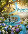 Solar-powered Cascade Bird Bath with blue water feature hanging in garden, surrounded by flowers, eco-friendly decor.