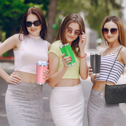 Three women holding colorful 20 Ounce Stainless Steel Tumblers With Secure Lid Pink Insulated Coffee Cup durable and stylish.