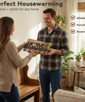 Solid Wall Mounted Key Rack With Five Heavy Duty Hooks Gonna Keep Your Daily Grind Organized Top Shelf Entryway Storage For Keys Bags And Pet Leashes Black in a modern living room, held by a man and a woman.