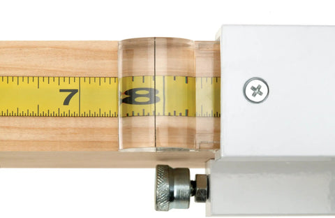Broset Precision Stop Block W1109 for crosscuts on miter saws and radial arms, showing magnified hairline cursor on a measuring tape