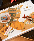 High Quality Brass Paper Fasteners 3/4 Inch Round Metal Brads securing scrapbook pages featuring travel themes and photo elements.