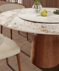 53 Inch Round Dining Table With Smooth Rotating Lazy Susan And Solid Hourglass Base Delivers A Clean Marble Look Top Crafted For Relaxed Weekend Hangouts Seats 6 To 8 In Brown featuring faux marble top and wooden hourglass base.