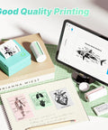 Portable Mini Sticker Printer With Three Thermal Rolls Compact Wireless Label Maker For Teachers And Craft Crews Dead Simple Setup displayed with printed labels on a desk.