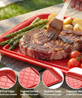 Stackable Grilling Prep And Serving Trays Set Of 2 Plastic BBQ Trays For Raw And Cooked Food Dishwasher Safe 17 By 10.5 Inches Outdoor Cooking Accessories For Parties Red And Black with steak and vegetables on red tray, spill-proof edges shown.