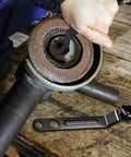 Heavy Duty Angle Grinder Wrench Tool Built Like A Tank With Thickened Four Claws securely gripping a locking nut.