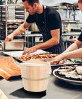Kickin Flavor Infusion Starts With This Handmade Wooden Rice Steamer Bucket And Tight Fitting Lid Built On A Heavy Duty Stable Base Along With Heat Safe Handles For Daily Meal Prep, shown in a busy kitchen.